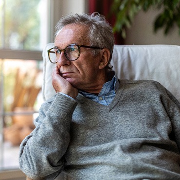A sad man looking out a window