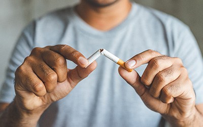 Closeup of patient breaking cigarette