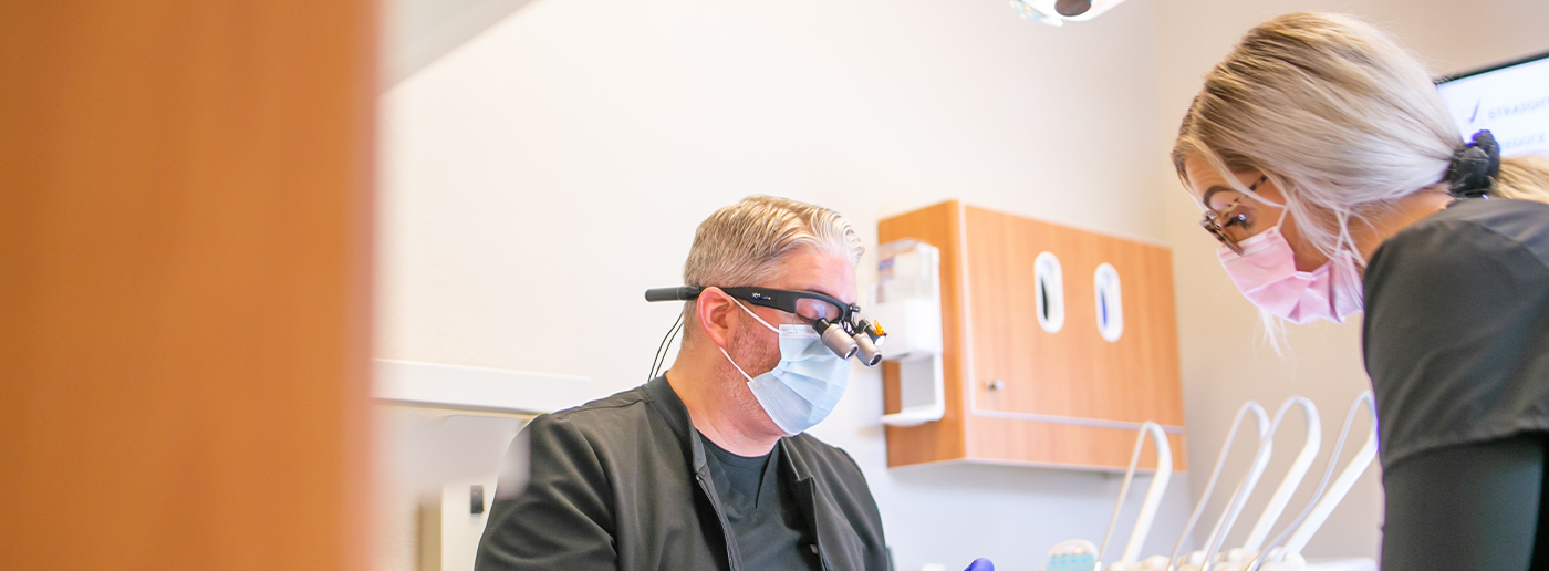 Doctor Daaboul and dental assistant treating a patient by replacing missing teeth in Grapevine