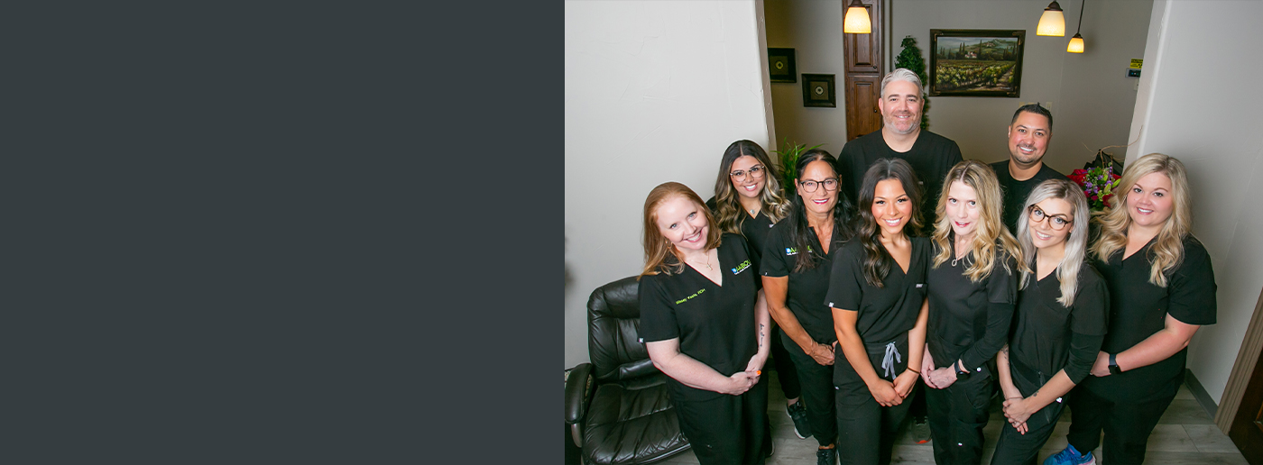 Smiling Grapevine dentist and team in dental office reception area