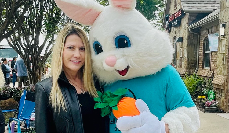 Woman smiling with person in bunny costume