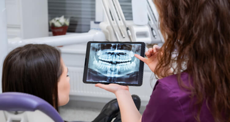 patient learning more about cost of tooth extractions in grapevine