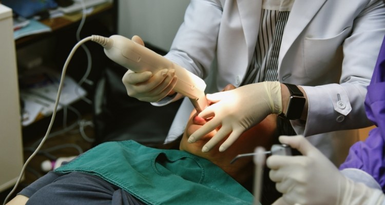 Dentist capturing digital dental impressions of a patient