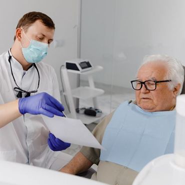 Senior dental patient reviewing paperwork