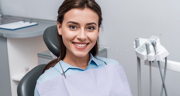 Young brunette woman smiling in dental chair