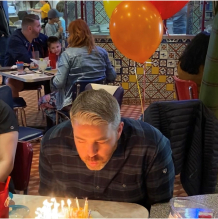 Doctor Daaboul blowing candles out on birthday cake