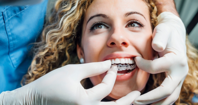 Dentist fitting a patient with an Invisalign clear aligner