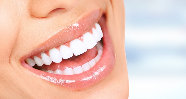 Close up of person smiling with straight white teeth