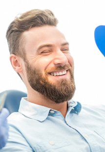 patient smiling in dental mirror 