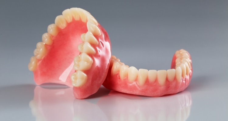 Two full dentures resting on table