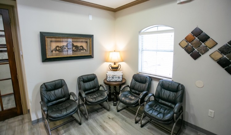 Black leather chairs in reception area of dental office